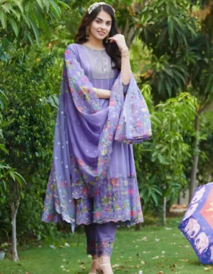 Purple cotton anarkali kurti with floral print dupatta and embroidered neckline, worn with matching printed leggings and white hair accessory