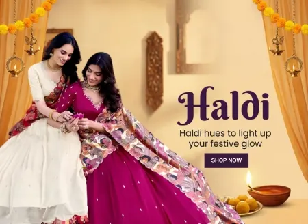 A smiling woman wearing a yellow floral saree with a gold border stands amidst festive Haldi decorations, including orange curtains, marigold garlands, and hanging brass lamps. In the foreground are a plate of traditional Indian sweets and a lit oil lamp. The text on the right reads "Haldi: Haldi hues to light up your festive glow" in purple script.