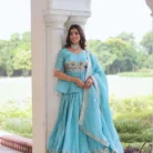 "Close-up of intricately embroidered dupatta with designer lace border featuring gold zari work and floral motifs on turquoise fabric"