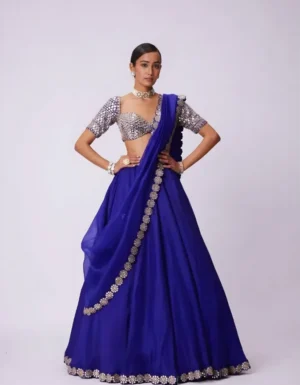 Intricate foil mirror work embellishment on royal blue lehenga creating a stunning festive and bridal aesthetic